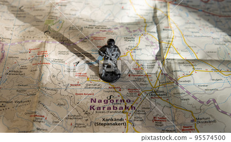 A figurine of an armed soldier on the map of Nagorno-Karabakh. 95574500