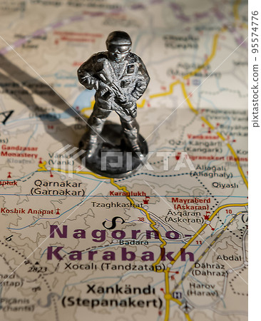 A figurine of an armed soldier on the map of Nagorno-Karabakh. 95574776