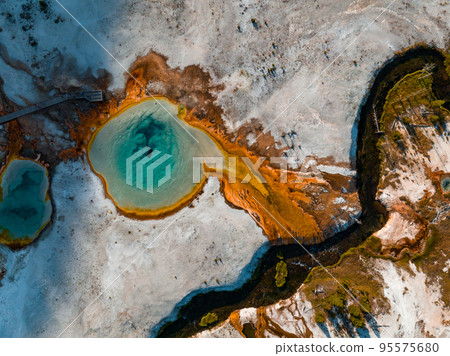 Beautiful geysers with hot water and steam with pools of thermophilic bacteria in the Upper Geyser Basin of Yellowstone National Park, Wyoming, United States. Beautiful geysers with hot water and steam with pools of thermophilic bacteria in the Upper Geyser Basin of Yellowstone National Park, Wyoming, United States. 95575680