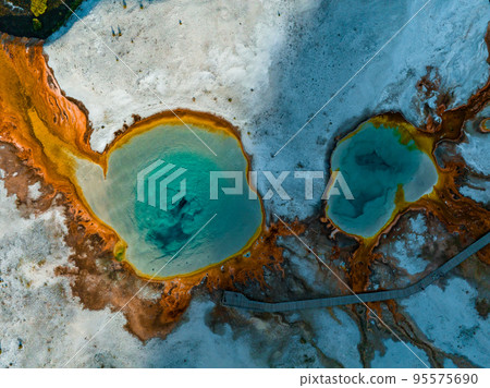 Beautiful geysers with hot water and steam with pools of thermophilic bacteria in the Upper Geyser Basin of Yellowstone National Park, Wyoming, United States. 95575690