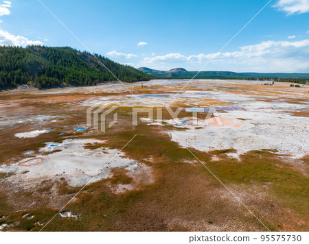 Beautiful geysers with hot water and steam with pools of thermophilic bacteria in the Upper Geyser Basin of Yellowstone National Park, Wyoming, United States. Beautiful geysers with hot water and steam with pools of thermophilic bacteria in the Upper Geyser Basin of Yellowstone National Park, Wyoming, United States. 95575730