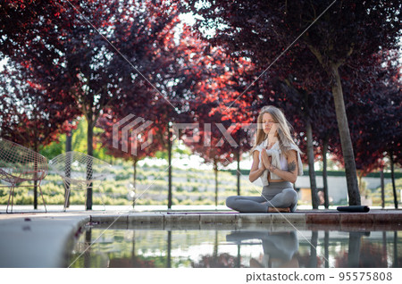 Girl practice yoga meditation outdoor in park Girl practice yoga meditation outdoor in park 95575808