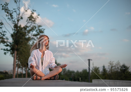 Girl practice yoga meditation outdoor in park Girl practice yoga meditation outdoor in park 95575826