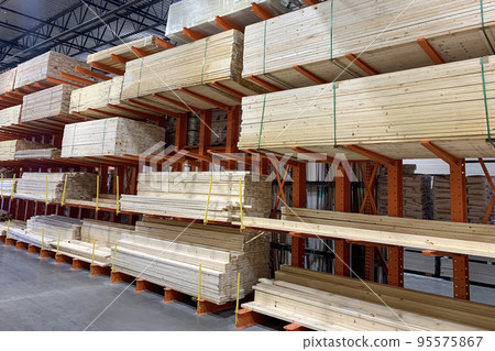 Wood factory stock or timber in warehouse. Piles of wooden boards waiting for shipping. Lumber, Business, production, manufacture and woodworking industry concept 95575867