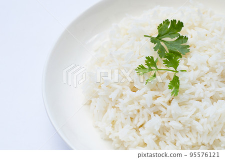 Dish of rice on white background. 95576121