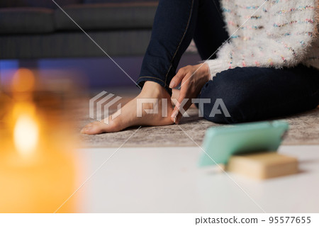 A woman relaxing at home at night 95577655