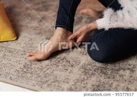 A woman relaxing at home at night A woman relaxing at home at night 95577657