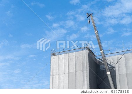 Blue sky, crane and construction site Blue sky, crane and construction site 95578518