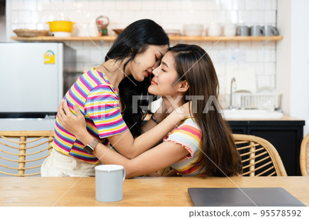 lgbtq, lgbt concept, homosexuality, portrait of two Asian women posing happy together and showing love for each other while being together. 95578592