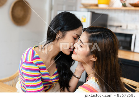 lgbtq, lgbt concept, homosexuality, portrait of two Asian women posing happy together and showing love for each other while being together. 95578593