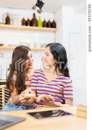 lgbtq, lgbt concept, homosexuality, portrait of two Asian women posing happy together and showing love for each other while being together. lgbtq, lgbt concept, homosexuality, portrait of two Asian women posing happy together and showing love for each other while being together. 95578598