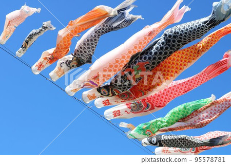Carp streamers blowing in the wind and swimming in the blue sky Scenery Carp streamers blowing in the wind and swimming in the blue sky Scenery 95578781