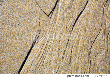 Close up of natural sand surface at the beach after low tide 95579353
