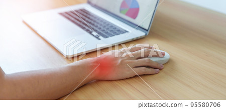 Woman having wrist pain when using mouse during working long time on workplace. De Quervain s tenosynovitis, Intersection Symptom, Carpal Tunnel Syndrome or Office syndrome concept Woman having wrist pain when using mouse during working long time on workplace. De Quervain s tenosynovitis, Intersection Symptom, Carpal Tunnel Syndrome or Office syndrome concept 95580706