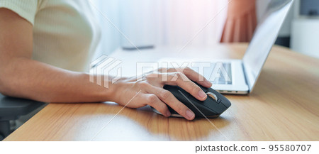 woman hand using ergonomic vertical mouse during working on Adjustable desk, prevention wrist pain. De Quervain s tenosynovitis, Intersection Symptom, Carpal Tunnel or Office syndrome concept woman hand using ergonomic vertical mouse during working on Adjustable desk, prevention wrist pain. De Quervain s tenosynovitis, Intersection Symptom, Carpal Tunnel or Office syndrome concept 95580707