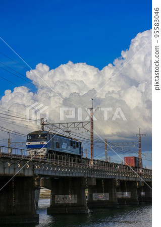 Freight train EF210-123 Momotaro running against the background of summer thunderheads 95583046