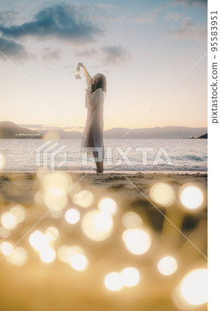 Photo of a woman standing by the beach 95583951