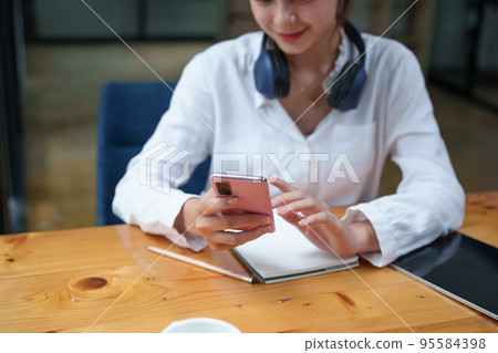 Portrait of a teenage girl using her phone to make video calls or call friends 95584398