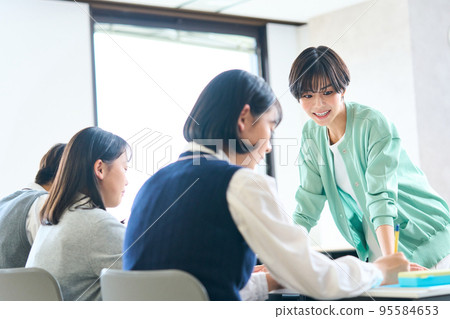 Teacher giving guidance Junior high school student studying High school exam Teacher giving guidance Junior high school student studying High school exam 95584653