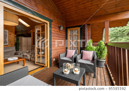 Beautiful wooden country home in the village. Cozy terrace with chairs and table in vacational house for rent. 95585592