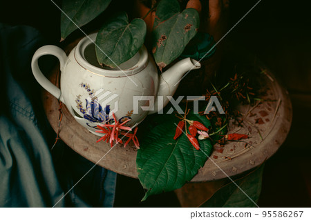 Broken porcelain tea kettle decorated with flowers to show the concept of healing, mental health and resilience  95586267
