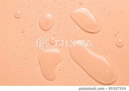 Drops of micellar water or cosmetic tonic on an orange background. Close-up, macro photography Drops of micellar water or cosmetic tonic on an orange background. Close-up, macro photography 95587359