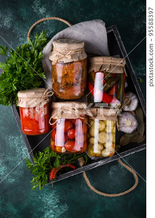 Pickled vegetables in glass jars. Pickled vegetables in glass jars. 95588397