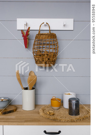 Modern kitchen interior with gray wooden panels on the wall in Scandinavian style, crockery and kitchen utensils Modern kitchen interior with gray wooden panels on the wall in Scandinavian style, crockery and kitchen utensils 95588948