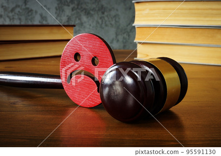 Sad smiley and gavel as concept of anti bullying law. 95591130