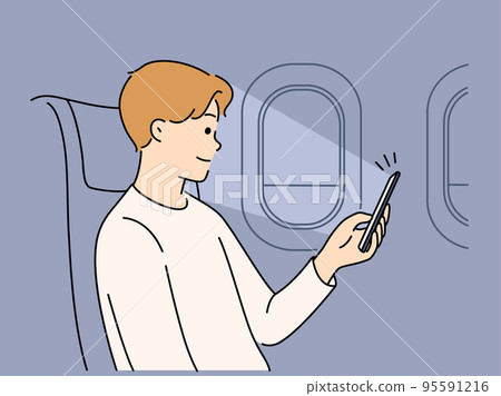 Man using cellphone on plane  95591216