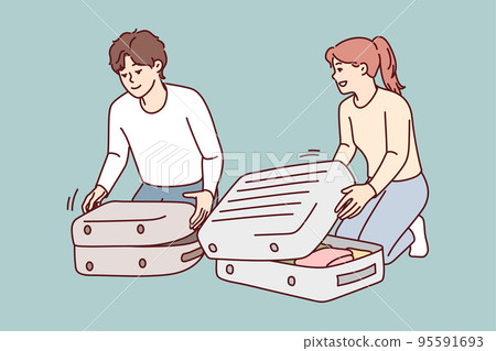 Happy couple packing suitcases  95591693