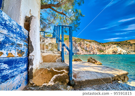 Weathered stairway to sea waters of bay on Greek island on sunny day. Weathered stairway to sea waters of bay on Greek island on sunny day. 95591815