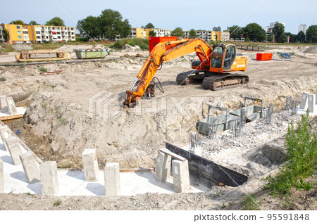 Concrete piles foundation for a new building on construction site Concrete piles foundation for a new building on construction site 95591848