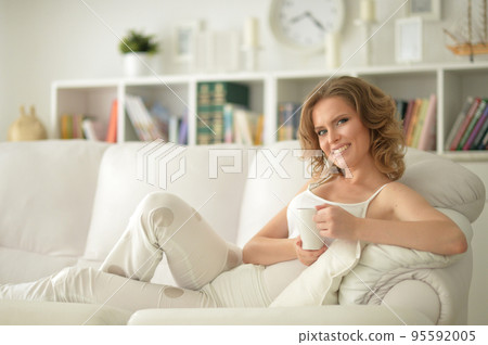 Portrait of a beautiful woman with a laptop on the sofa Portrait of a beautiful woman with a laptop on the sofa 95592005