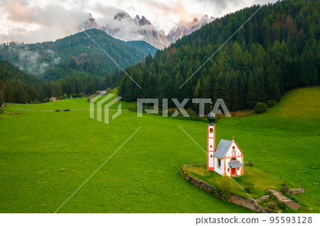 Magnificent Santa Maddalena village with old St. Johann church in the Dolomites in valley Val di Funes, South Tyrol, Italy, aerila view Magnificent Santa Maddalena village with old St. Johann church in the Dolomites in valley Val di Funes, South Tyrol, Italy, aerila view 95593128