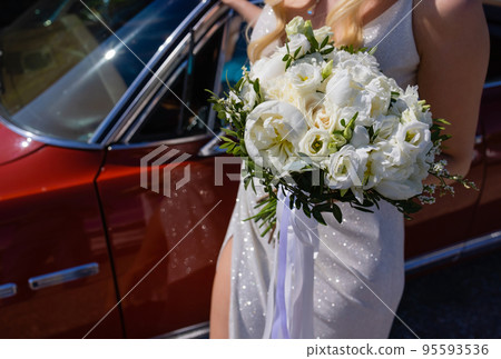 This is wedding bouquet at bride's hands. 95593536