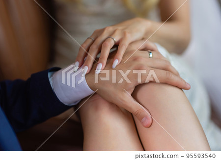 Man's hand gently holding woman's hand - closeup shot. Man's hand gently holding woman's hand - closeup shot. 95593540
