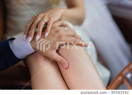 Man's hand gently holding woman's hand - closeup shot. Man's hand gently holding woman's hand - closeup shot. 95593542