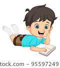 Cute little boy laying and reading a book 95597249