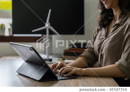 Real Estate Agent showing a energy project for future house. Green energy development concept Real Estate Agent showing a energy project for future house. Green energy development concept 95597359