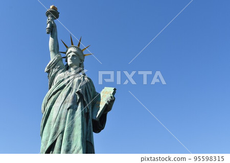 Statue of Liberty against the blue sky 95598315
