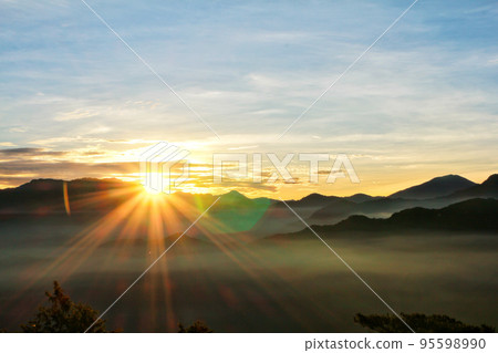 Sun set view over mountains with fog on floor ground in the morning. Alishan National Forest Recreation Area in Chiayi County, Alishan Township, Taiwan Sun set view over mountains with fog on floor ground in the morning. Alishan National Forest Recreation Area in Chiayi County, Alishan Township, Taiwan 95598990