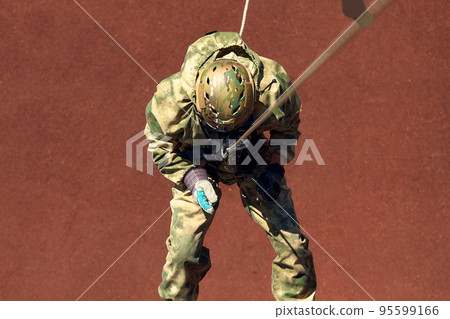 Special forces fighter descends from a skyscraper to storm the apartment. Police, counter terrorism concept. Mixed media 95599166