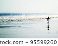 Young boy dancing on the beach 95599260