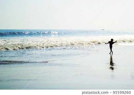Young boy dancing on the beach Young boy dancing on the beach 95599260