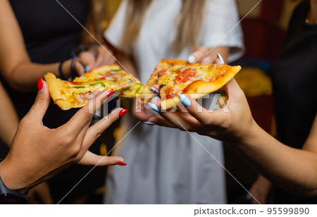 Group of people eating delicious pizza. 95599890