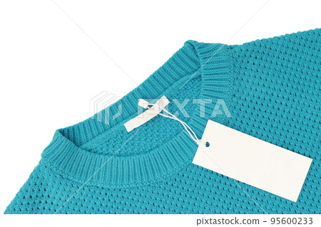 White blank rectangular clothing tag on turquoise knitted sweater isolated on white background 95600233