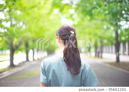 A back view of a long-haired woman taking a walk with her hair flowing A back view of a long-haired woman taking a walk with her hair flowing 95601293