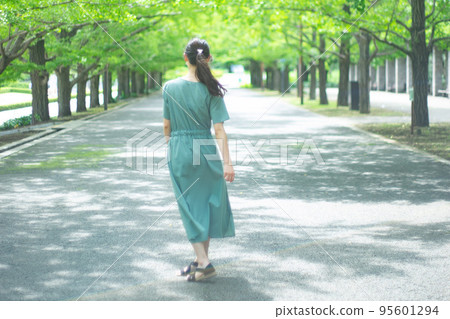 A back view of a long-haired woman taking a walk with her hair flowing A back view of a long-haired woman taking a walk with her hair flowing 95601294