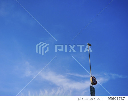 A view of the highway streetlights and the expansive blue sky A view of the highway streetlights and the expansive blue sky 95601787